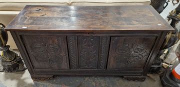 19th century oak coffer converted to a sideboard, having a hinged lid over a three-panel front,