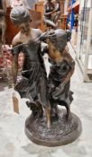 Cast metal group with a bronzed finish of two sisters picking flowers in a garden, 70cm high