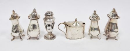 Two pairs of silver pepperettes of baluster design on four hoof feet, an oval silver mustard pot and