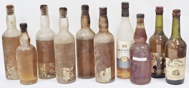 Five unlabelled bottles, possibly whisky with varying levels, a bottle of self-labelled Stinkyburn