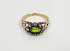 Antique gold-coloured ring set oval cut green stone surrounded by old cut white stones, probably