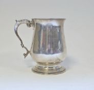 Silver mug by Asprey & Co Limited, London 1989, of plain baluster form with leaf cap scroll