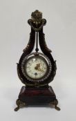French lyre mantel clock, the mottled red lacquered frame mounted by a gilt metal sunburst finial