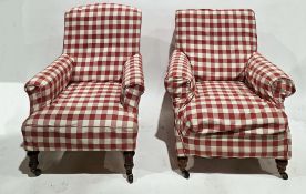 Two 19th century armchairs, both with loose red gingham covers, on front turned legs with castors,
