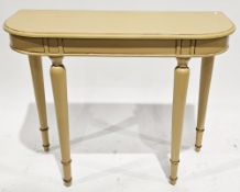 Mustard-coloured distressed painted console table with rounded front corners, on turned tapering