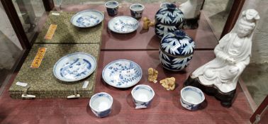 Chinese blanc-de-chine figure of Guanyin on a wooden stand, possibly Kangxi (1662-1722), seated with