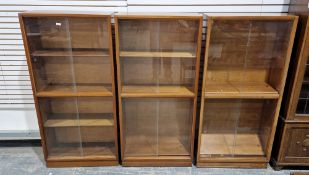 Three mid-century Maples Furniture teak cabinets/bookcases, each cabinet with two pairs of glass