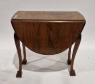Polished walnut oval-topped swing leg table on claw and ball supports, 75cm high x 109cm long x 75cm