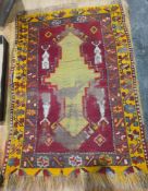 Eastern red ground rug with central geometic medallion and lozenge design, multiple geometric