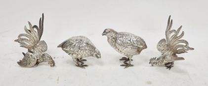 Pair of white metal models of fighting cockerels, probably continental, 14cm high together with a