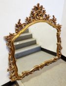 Modern gilt-effect framed mirror in the Rococo manner, with moulded foliate scroll and floral frame,