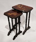 Nest of two Japanese black side tables, the tops with a lacquered finish having chinoiserie