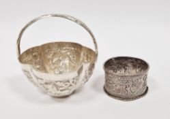 Indian white metal basket of lobed form with panels depicting a figure and animals, the handle