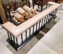 Contemporary club fender, the tan leather studded upholstered seat on a black metal base with square