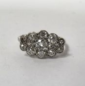 Platinum and diamond boat-shaped cluster ring, illusion set with fifteen old cut diamonds (largest