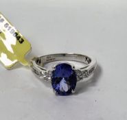 18k white gold and tanzanite diamond ring, claw set with an oval mixed cut tanzanite (approx. 9.45mm