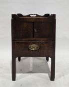 George III mahogany commode night stand, the shaped tray top with pierced handles over two pot
