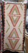 Cream ground kilim rug with two geometric hooked motifs, single colour border, 100cm x 47cm