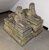 Pair of composite stone garden statues modelled as Egyptian Sphinx on rectangular bases, 94cm high x