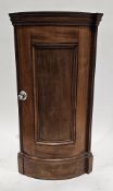 19th century mahogany bowfronted floor-standing corner cabinet, the single panel door opening to two
