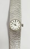 Lady's Omega 9ct white gold bracelet watch, the circular silvered dial with baton markers, on