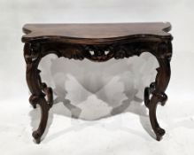 French-style mahogany side table, the shaped top over a foliate carved frieze, on carved scrolling