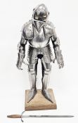 Vintage miniature model of a 15th century Gothic style suit of armour, mounted on a fabric covered