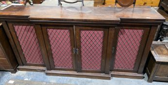 Regency rosewood breakfront sideboard, the four doors with burgundy fabric lined brass mesh