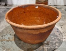 Large 19th century terracotta dairy bowl with a glazed interior surface, 34cm high x 63cm