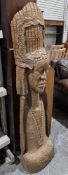 Hardwood carved sculpture of a South East Asian figure with decorative headdress and necklace, 144cm