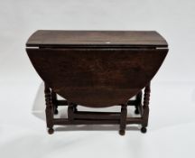 18th century oak gateleg table of oval form, having a drawer to one end, on turned bobbin and