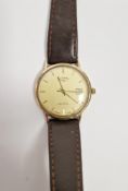 Gent's 9ct gold Rotary quartz strap watch, the circular dial with baton markers and date aperture