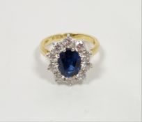 18ct gold, sapphire and diamond cluster ring, the central oval cut sapphire (2.42ct approx, dark