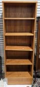 Modern veneered bookcase of rectangular form with four adjustable shelves, on a deep plinth base,
