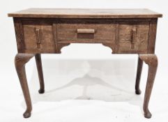 Early 20th century oak side table/lowboy, the rectangular top over three drawers with moulded