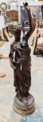 Cast metal figure with a bronzed finish of a neoclassical maiden holding a lyre, 99cm high