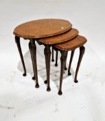 Burr walnut and walnut nest of three tables, the oval tops with shaped edges, on carved cabriole