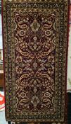 Belgian red ground rug with floral field, multiple floral borders, 130cm x 66cm