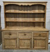Large 19th century pine dresser, the upper section with shaped frieze over two plate shelves