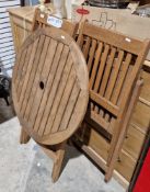 Teak slatted garden folding table and two chairs, the circular table 78cm high x 70cm diameter and