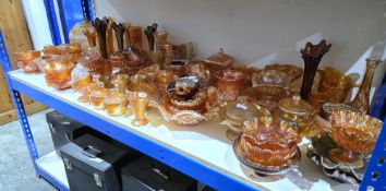 Large collection of carnival glass, amber, gold and petrol tinted, including: frilled bowls, rose