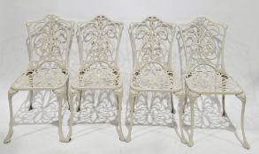 Set of four garden metal chairs with a cream finish, having foliate scrolling pierced back and