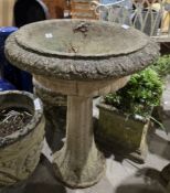 Reconstituted stone deep birdbath or planter of acanthus leaf design on a cast moulded column,