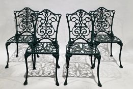 Set of four garden metal chairs with a green finish, having foliate scrolling pierced back and