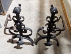Pair of iron firedogs with scrolling decoration, 44cm high