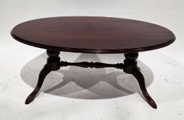 Mahogany-effect oval coffee table on four splayed legs, 44cm high x 102cm long