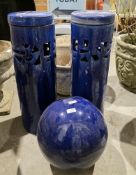 Three blue glazed garden ornaments viz a pair of cylindrical planters with covers, 62cm high and a