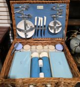 Mid-20th century Sirram wicker picnic basket fitted to the interior with plates, cutlery, thermos