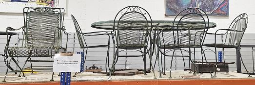 Metal garden dining table and chairs, the glass topped table of oval form, 72cm high x 175cm long