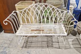 Wrought iron garden bench with slatted seat, scroll arms and arched back, painted white, 130cm